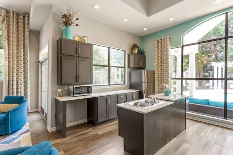 Clubhouse kitchen with island sink, cabinets and refrigerator