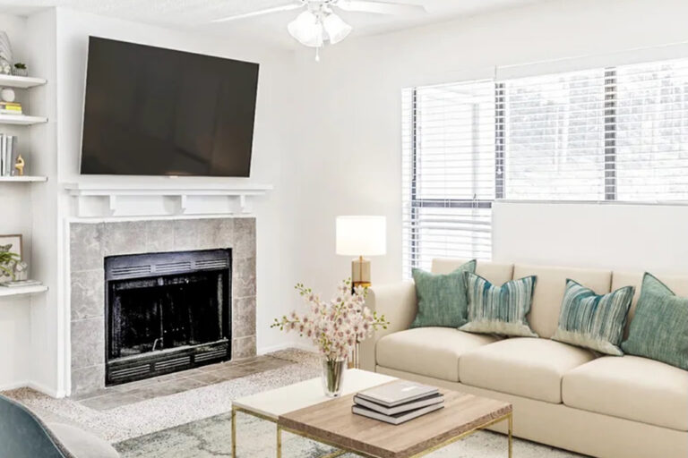Apartment living room with fireplace, mounted TV and sofa