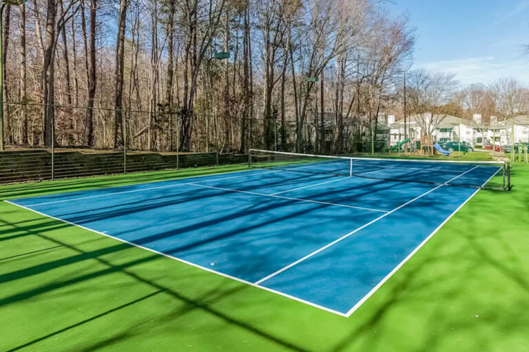 Tennis court surrounded by trees